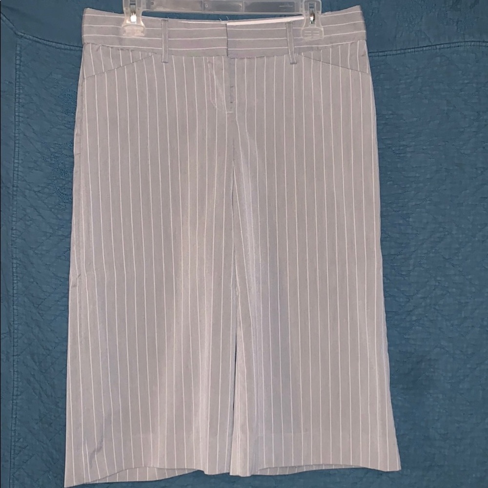 Gray pants with vertical, thin white stripes.